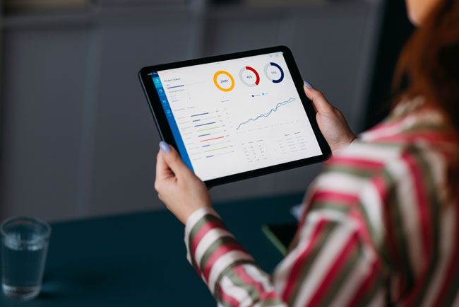 A small business owner reviews data from a fuel card in real-time on her tablet.