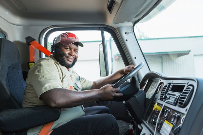 A truck driver fuels up his rig with a fleet fuel card.