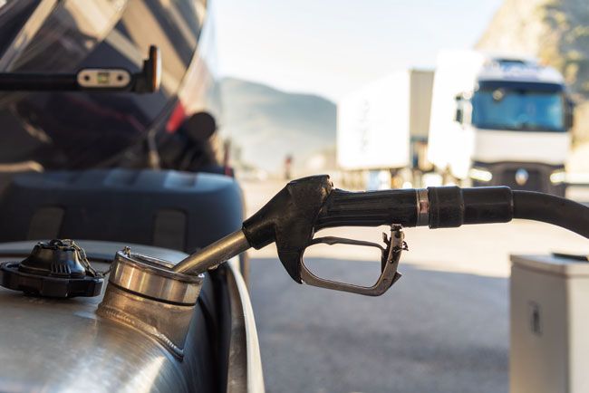 Image of a gas pump fueling a semi truck.