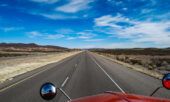 View of a highway from the point of view of a semi truck fleet driver.