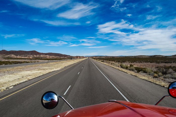 View of a highway from the point of view of a semi truck fleet driver.