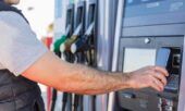 A fleet driver pays for his fuel with his phone at the pump.